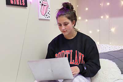 Student remote learning in their dorm room